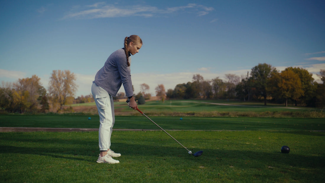 A golfer at the beginning of her swing