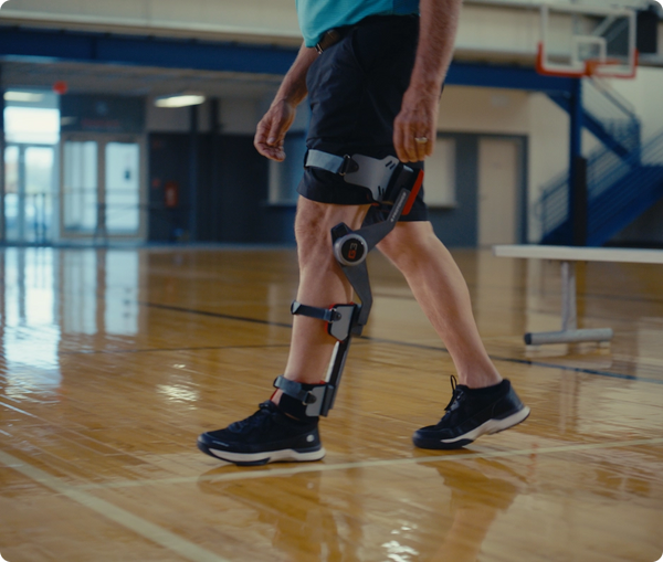 Person walking with a G3 device on a basketball court