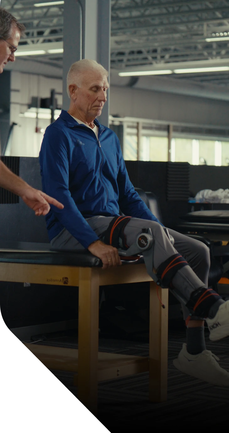 Person receiving physical therapy with a therapist in a clinical setting